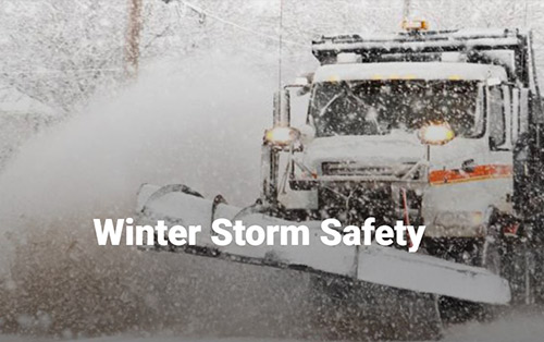 Snow plow removing snow from street