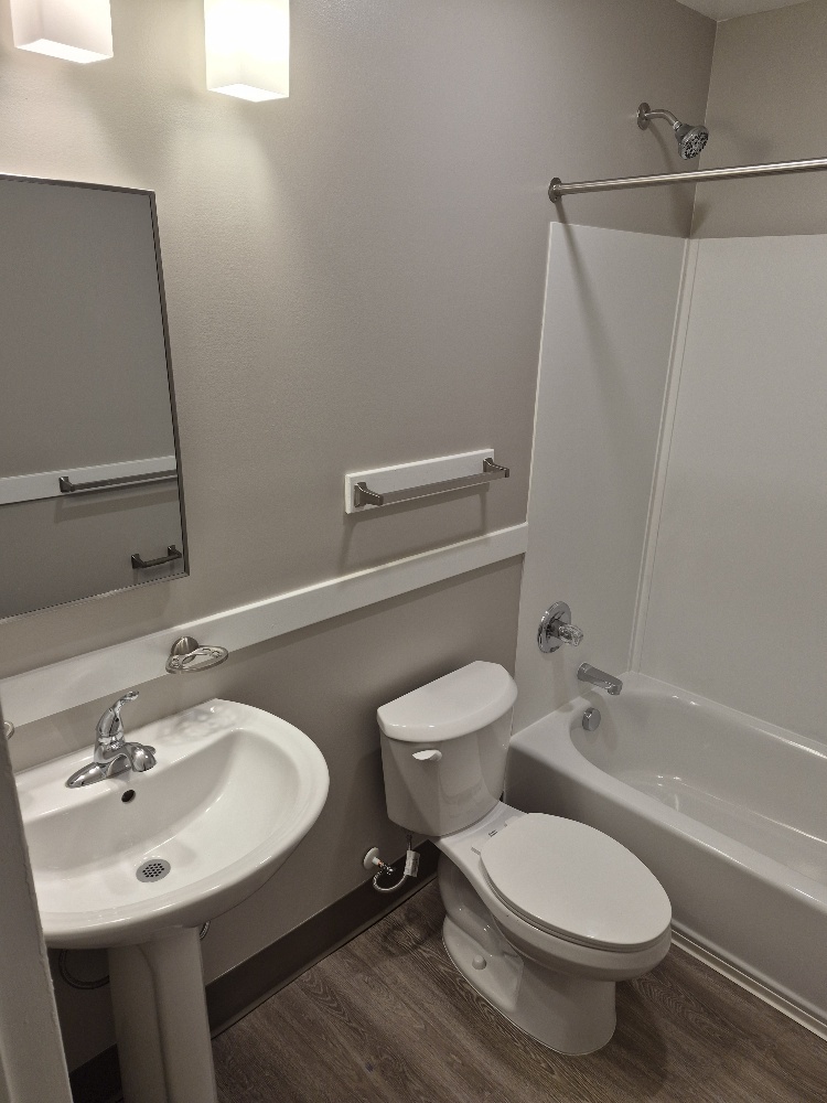 A bathroom view of the sink, toilet, and shower.