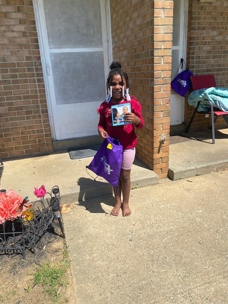 Woodrail youth resident receives summer reading package from Alamance Achieves.
