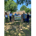 BHA and Alamance Achieves staff pose in front of Woodrial Acres sign.