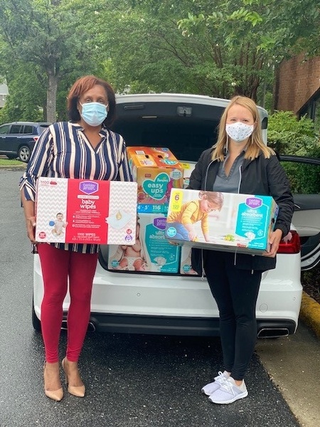 BHA Executive Director receives donation of diapers, wipes and hygiene products from Alamance Service League representative. 