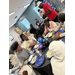  7 people sit around a table talking and eating. 