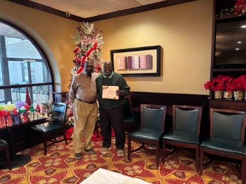 A man with Tim Jeffers receiving a 10 years of service award.