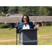  CEO Veronica Revels giving a speech in a field outside at a podium. 